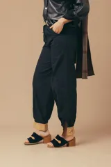 Sandalias tipo mules de gamuza azul con detalle de hebilla dorada y taco de madera.