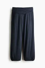 Pantalón globo negro de punto de viscosa, con cintura elástica ancha fruncida y piernas anchas con elástico revestido en los tobillos.