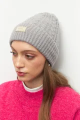 Gorro de lana tejido en ochos con vuelta acanalada y parche frontal con logo de la marca Daniel Cassin.