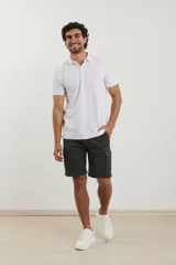 Remera tipo polo de color blanco, con cuello clásico, cierre de botones frontal y mangas cortas con terminación acanalada.