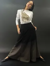 Falda larga de lana color negro con teñido degradado en tonos grises. Corte a la cintura con bolsillos laterales y cierre invisible.