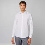 Camisa blanca de corte recto con estampado de lunares negros, cuello clásico y cierre frontal con botones.