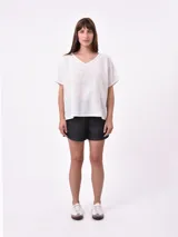 Blusa lila de corte holgado con cuello en V y mangas cortas.