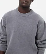 Suéter masculino de cuello redondo y manga larga, confeccionado en tejido fleece con textura suave. Presenta puños y ruedo acanalados, con un diseño minimalista y sin estampados.