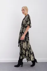 Vestido largo de viscosa con jacquard de flores en lurex dorado. Presenta escote en V cruzado, mangas al codo y elástico en la cintura con lazo ajustable. Incluye un viso al tono con breteles regulables.