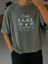 Remera oversize marrón con estampado gráfico frontal en tonos celestes y blancos con la leyenda "Only Fans", palmeras y estrellas.