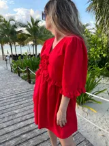 Vestido corto verde manzana de lino, con escote en V con volados y mangas abullonadas.