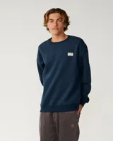 Buzo azul marino Rip Curl con cuello redondo, mangas largas y estampa trasera en color blanco con texto y logo de la marca.