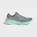 Championes de running Adidas Supernova Rise 2, color gris con detalles en verde menta y amarillo neón en la suela. Presentan una parte superior de malla transpirable y una entresuela gruesa con tecnología Dreamstrike+.