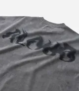 Remera oversized masculina de media malla con toque gamuza, color gris oscuro con efecto lavado. Presenta un bordado blanco en forma de media luna en el pecho y un estampado lettering en la parte delantera y trasera.