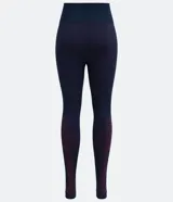 Legging deportiva de tiro alto confeccionada en tejido de poliamida sin costuras. Presenta un diseño ajustado al cuerpo con detalles geométricos contrastantes en la parte inferior de las piernas.