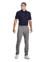Remera polo Under Armour Tech para hombre, color azul marino con logo gris bordado en el pecho. Confeccionada en tejido UA Tech™ de secado rápido y corte holgado.