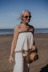 Top strapless color crema con detalle de ribete dorado en el borde superior.