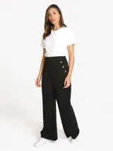 Pantalón negro de tiro alto Tommy Hilfiger de pernera ancha, con detalles de tres botones dorados en los laterales y cierre frontal.
