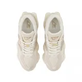 Championes New Balance modelo 9060, con diseño robusto y moderno en tonos beige y crema. Presentan una combinación de texturas en gamuza y malla, con la característica letra N en los laterales y una suela voluminosa con tecnología de amortiguación.