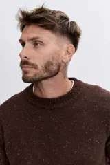 Sweater de punto de cuello redondo, con diseño jaspeado en tono marrón oscuro, de corte clásico y mangas largas con puños acanalados.