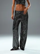 Pantalón largo de lentejuelas negras, de corte palazzo.