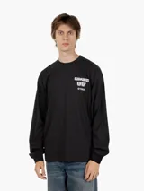 Camiseta de manga larga Carhartt WIP color negro con cuello redondo y puños elásticos. Presenta un pequeño estampado blanco en el pecho izquierdo con el logo "Carhartt WIP" y el año "©1989".