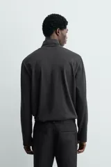 Camiseta de hombre manga larga y cuello perkins, de calce regular fit y color negro, confeccionada en tejido compacto de algodón.