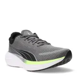 Championes de running Puma Scend Pro, color negro con detalles en blanco. Presentan una capellada de malla transpirable, cordones negros y una suela gruesa de espuma blanca con detalles negros en la parte inferior. En la lengüeta se lee 'PROSET'.