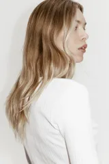 Top de manga larga en punto acanalado de algodón con diseño pointelle, escote en U con ribete festoneado y tapeta con botones al frente.