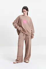 Pantalón de felpa negro con cintura elastizada ajustable, bolsillos laterales y corte acampanado.