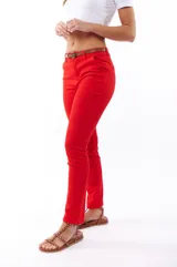 Pantalón rojo de corte recto, con bolsillos laterales y cinturón marrón.