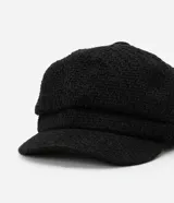 Boina negra de tweed con forma abullonada y visera curva.