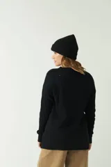 Cárdigan largo de punto color negro, con bolsillos y botones frontales.