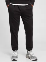 Pantalón deportivo de corte jogger, color negro, con cintura elástica y puños acanalados en los tobillos.