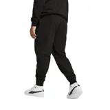 Pantalón de jogging negro con cintura elástica y puños acanalados. Presenta el escudo del Club Atlético Peñarol en la pierna derecha y el logo de PUMA en la pierna izquierda.