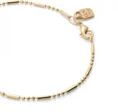 Pulsera dorada con eslabones formados por bolitas y piezas alargadas.