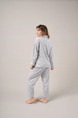 Pijama de dos piezas celeste con estampado floral, compuesto por camisa de manga larga abotonada y pantalón largo.