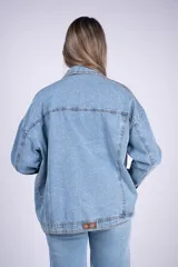 Campera oversize de denim de algodón en color celeste, con diseño de hombros caídos, bolsillos con solapa en el pecho y cierre frontal con botones.