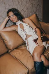 Top halter blanco de cuero con detalles dorados, ajustable en cuello, espalda y busto.