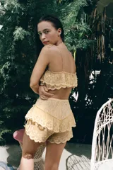 Shorts de tiro medio con cintura elástica, confeccionados en tejido con superposición de volantes, bordados florales y detalles de abalorios. Presenta tiras laterales ajustables con lazada.