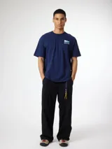 Remera azul marino de manga corta, con calce holgado y estampado gráfico geométrico en la espalda con diseño de cruces en tonos celestes y blancos.