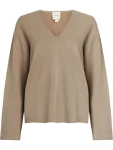 Sweater color beige de lana con escote en v, mangas largas y hombros caídos. Presenta logo de Calvin Klein en la parte superior trasera.