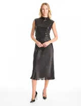 Vestido midi de satén negro con caída fluida y escote minimalista, acompañado por un top sin mangas de cuello alto cubierto de lentejuelas negras con detalle drapeado en la cintura.