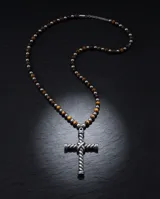 Collar de diseño artesanal compuesto por una cadena de cuentas alternadas de ónix y ojo de tigre, con un dije central de cruz de acero con diseño trenzado.
