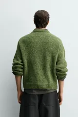Jersey de punto con estructura de torzal y efecto jaspeado, de corte relajado, cuello redondo y manga larga con acabados en rib.
