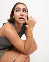 Pulsera dorada con eslabones grandes rectangulares y cierre de mosquetón.