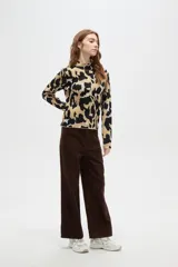 Polera de tejido jacquard con diseño abstracto, cuello alto y mangas largas, de corte ajustado al cuerpo.