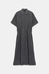 Vestido midi de corte camisero color gris, confeccionado con mezcla de lyocell y lino. Presenta cuello solapa, manga corta, pliegues en la cintura y cierre frontal con botones ocultos.