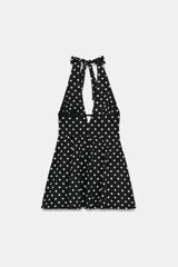 Vestido mini con cuello halter y escote en pico. Presenta un diseño con falda acampanada y cierre posterior con cremallera oculta.