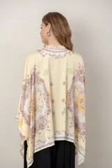 Camisa de seda modelo pañuelo, de color amarillo con estampado estilo mandala y flores, cuello redondo y cierre frontal con botones.