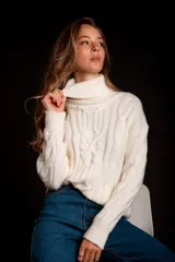 Suéter tejido de punto trenzado color salmón, con cuello alto y mangas largas. Corte ajustado al cuerpo.