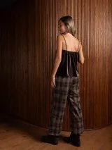 Top de terciopelo negro con breteles finos y detalle de encaje en el escote.