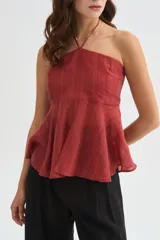 Top halter color amarillo claro, con escote strapless y detalle de argolla en el cuello, confeccionado en viscosa con diseño holgado y acabado fluido.