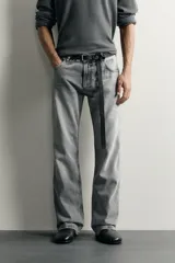 Jeans flare fit de denim de algodón en color gris con efecto lavado. Presentan diseño de cinco bolsillos, tiro medio y cierre frontal con cremallera y botón.